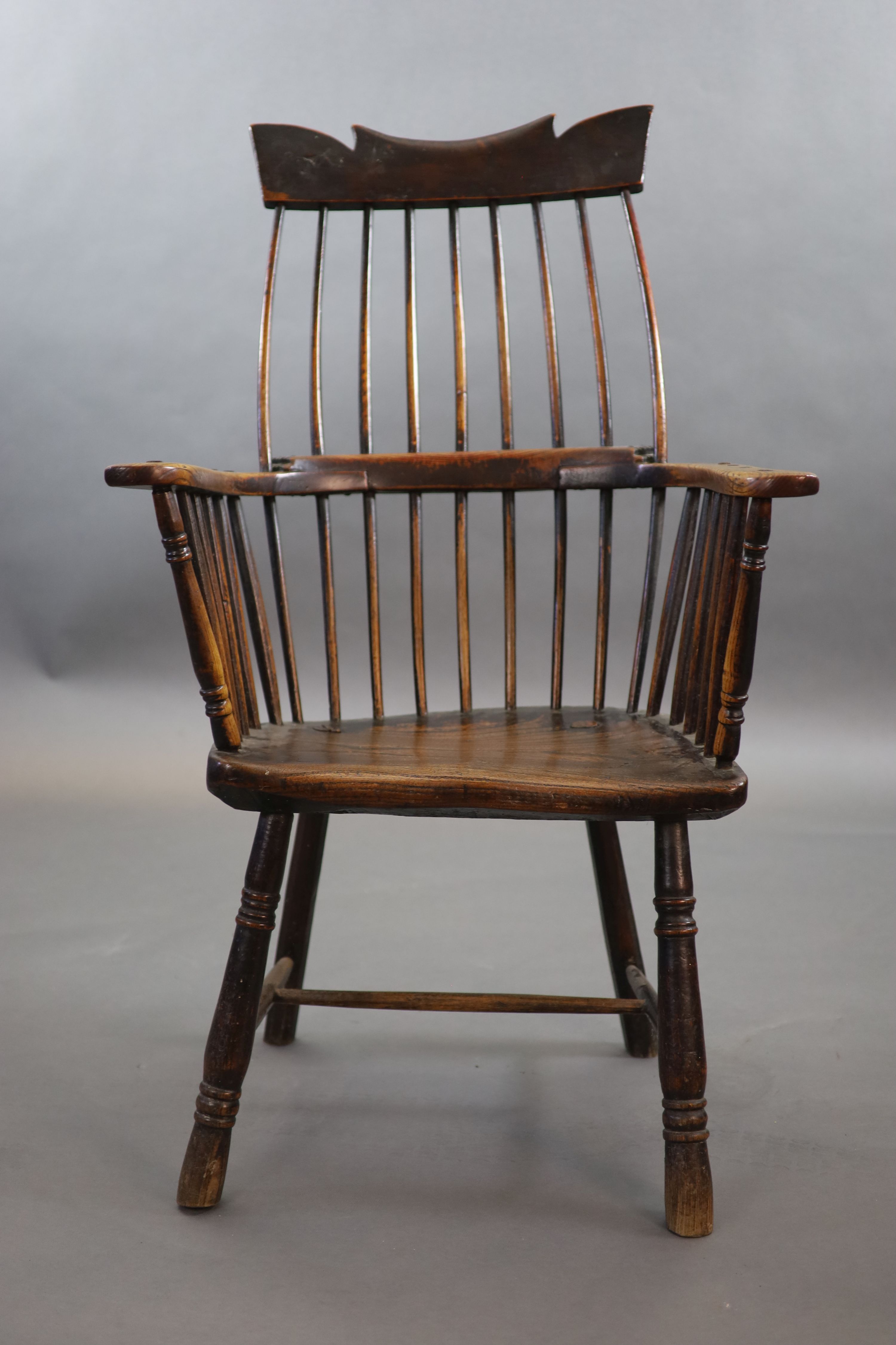 A primitive comb back Windsor armchair, possibly West Country, 67cm wide, 39cm deep, 106cm high.